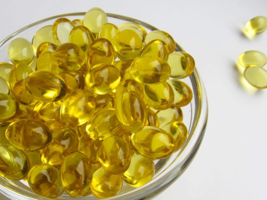 a bowl of vitamin D capsules